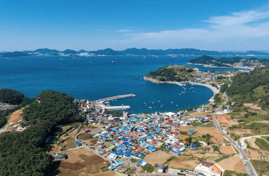 South Korea Tours a large body of water surrounded by a lush green hillside