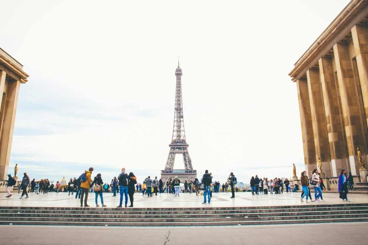 france tours people standing while watching Eiffel tower
