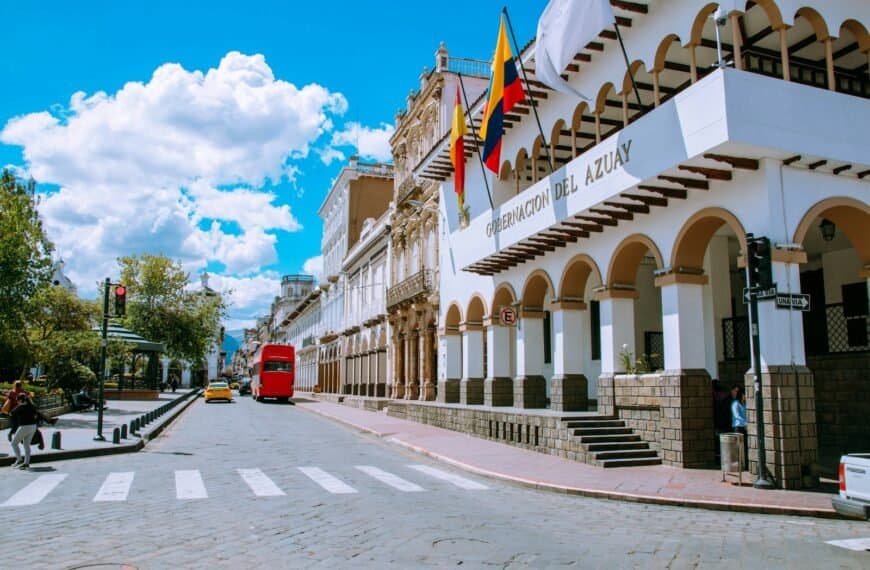 ecuador tours red car parked in front of white concrete building during daytime