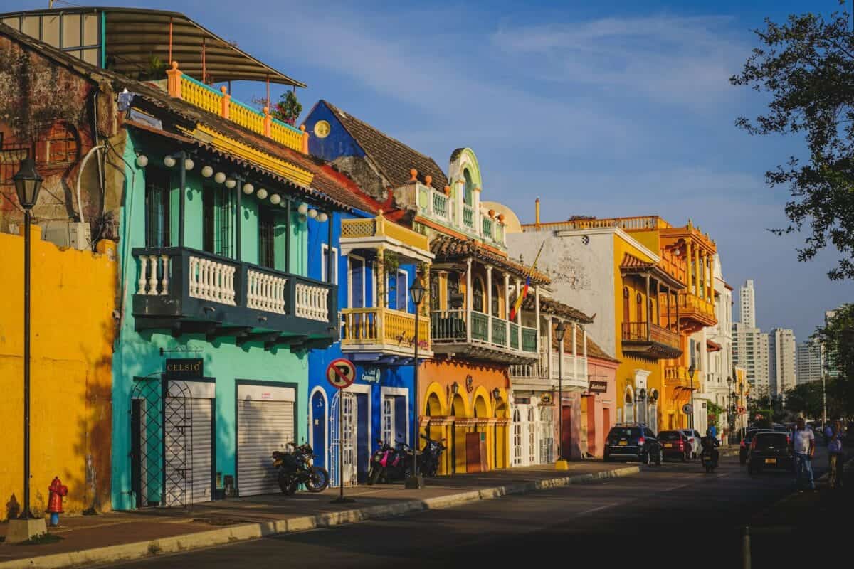Colombia Tours cars parked in front of green and white concrete building during daytime