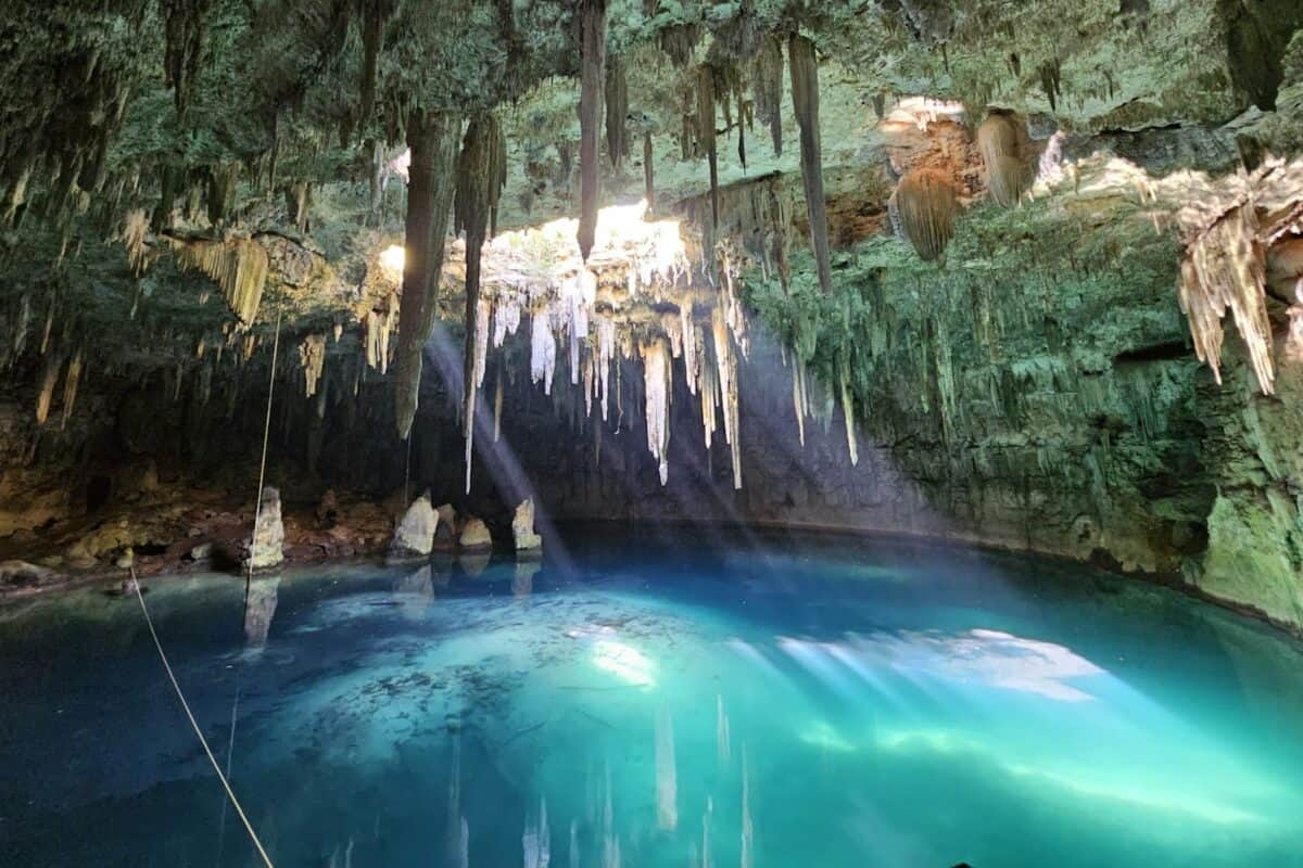 Xplor Park A blue pool in a cave with icicles hanging from the trees