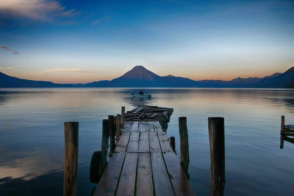 guatemala tours dock near water with cone mountain