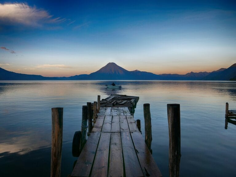 guatemala tours dock near water with cone mountain