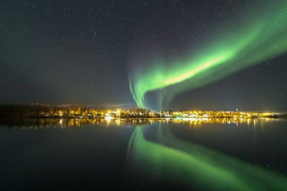 Saskatchewan travel guide the aurora bore is reflected in the water at night
