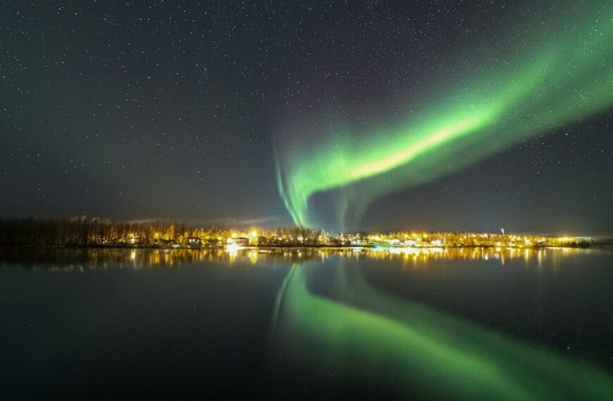 Saskatchewan travel guide the aurora bore is reflected in the water at night
