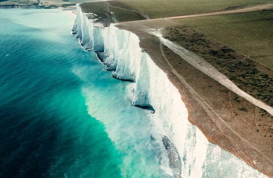 England Tours brown rocky mountain beside body of water during daytime