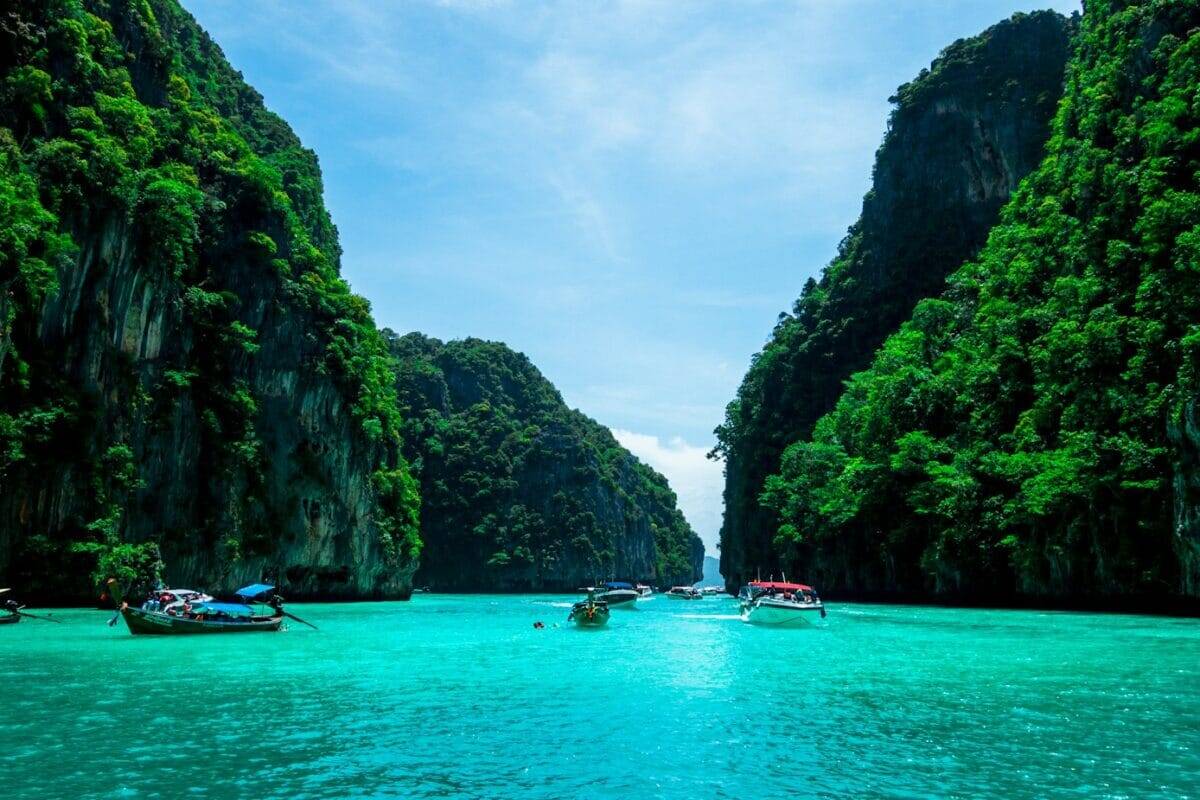 phuket tours boats on sea near mountain during daytime