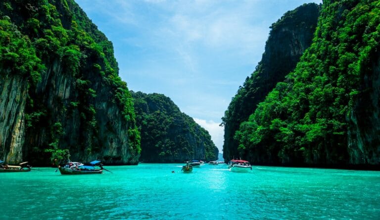 phuket tours boats on sea near mountain during daytime