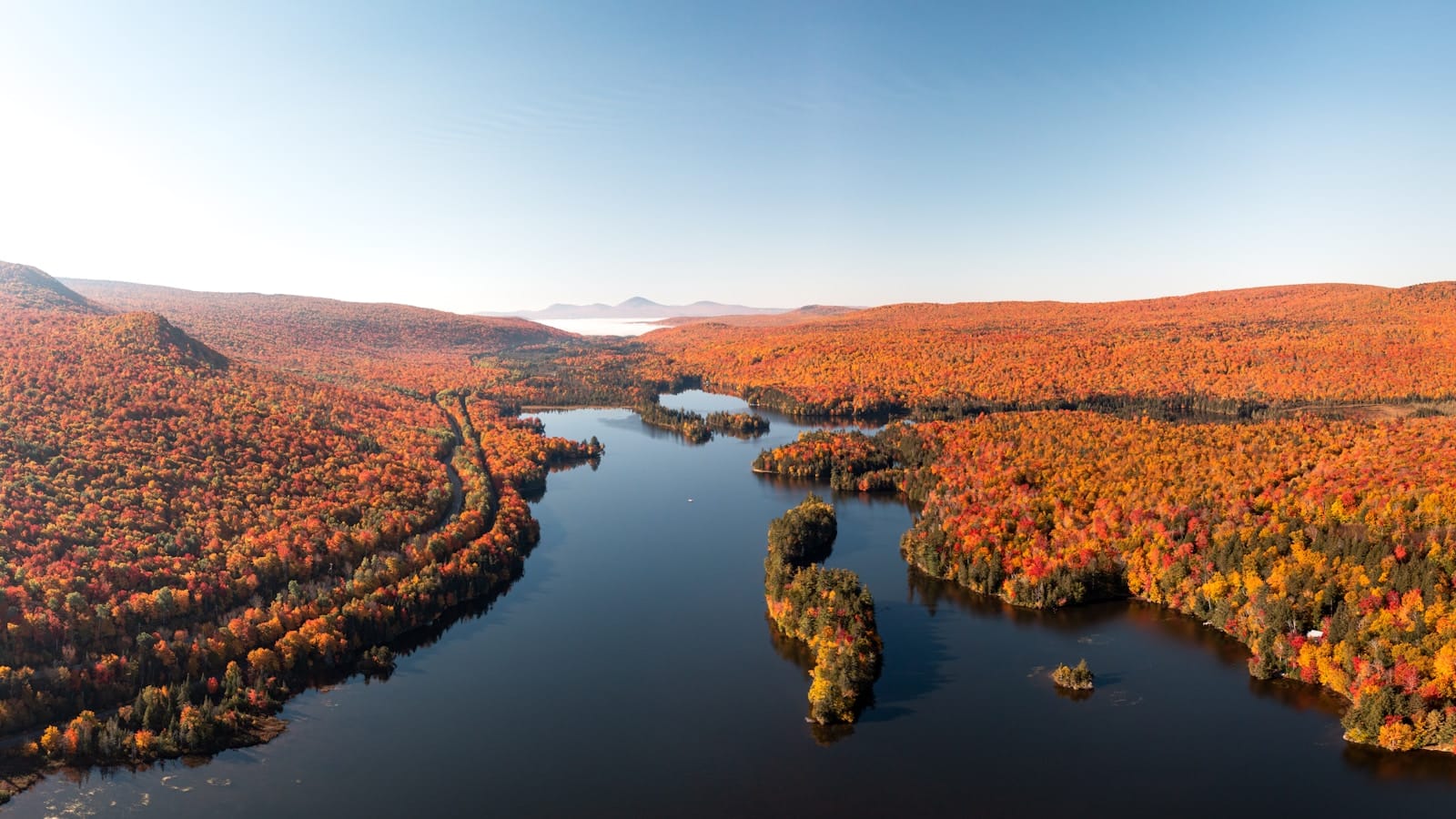 New England Tours a river with trees on the banks