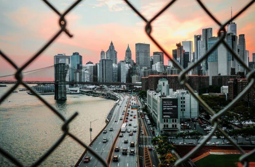urban travel guide gray concrete building near body of water under gray and white sky