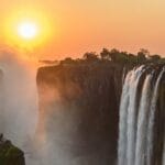 Zimbabwe Travel Guide waterfalls on brown rocky mountain during sunset