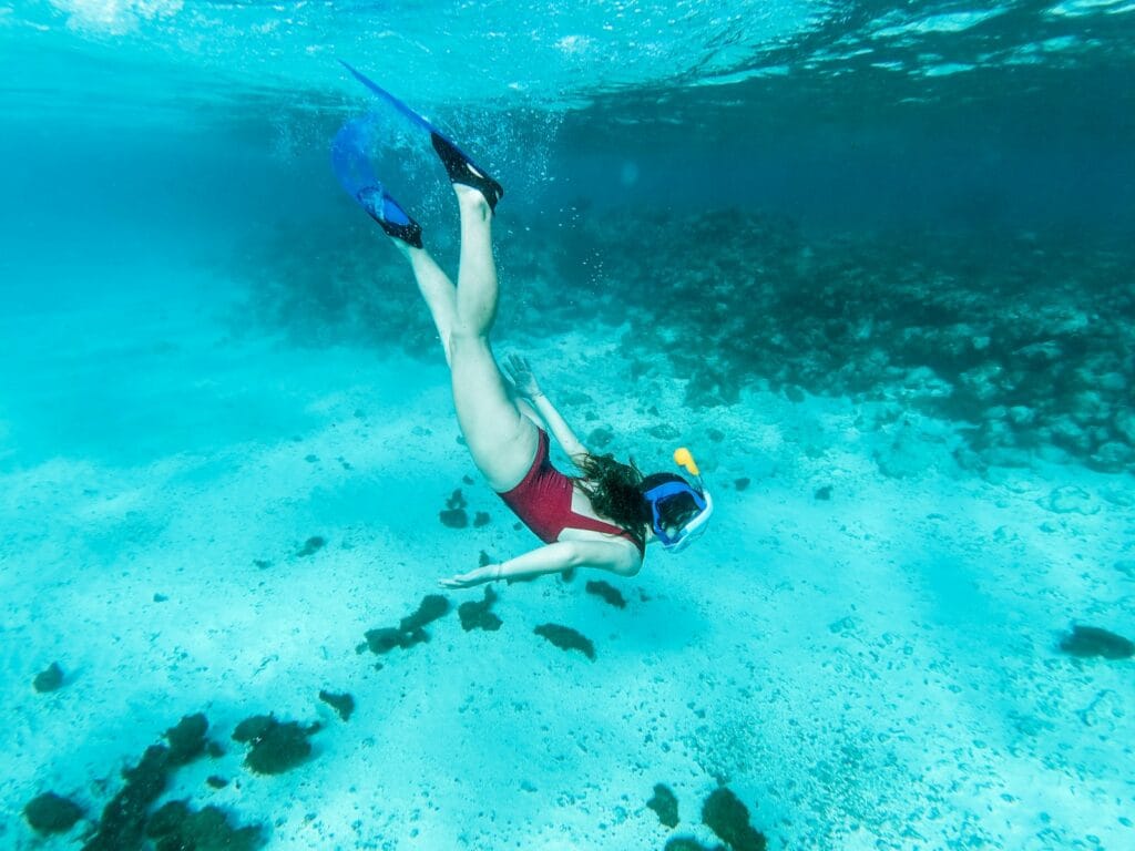 Molokini Crater Tours woman in blue and black bikini swimming in the sea