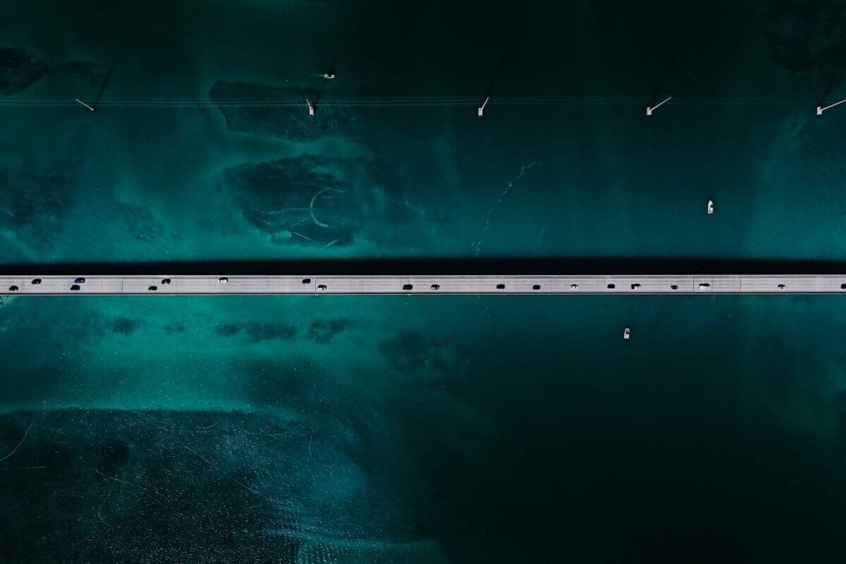 Key West Tours Bridge over teal water, from above.