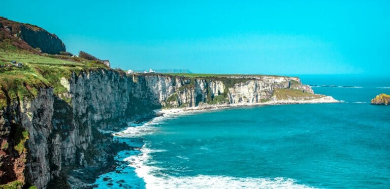 ireland travel guide white rock cliff beside body of water'