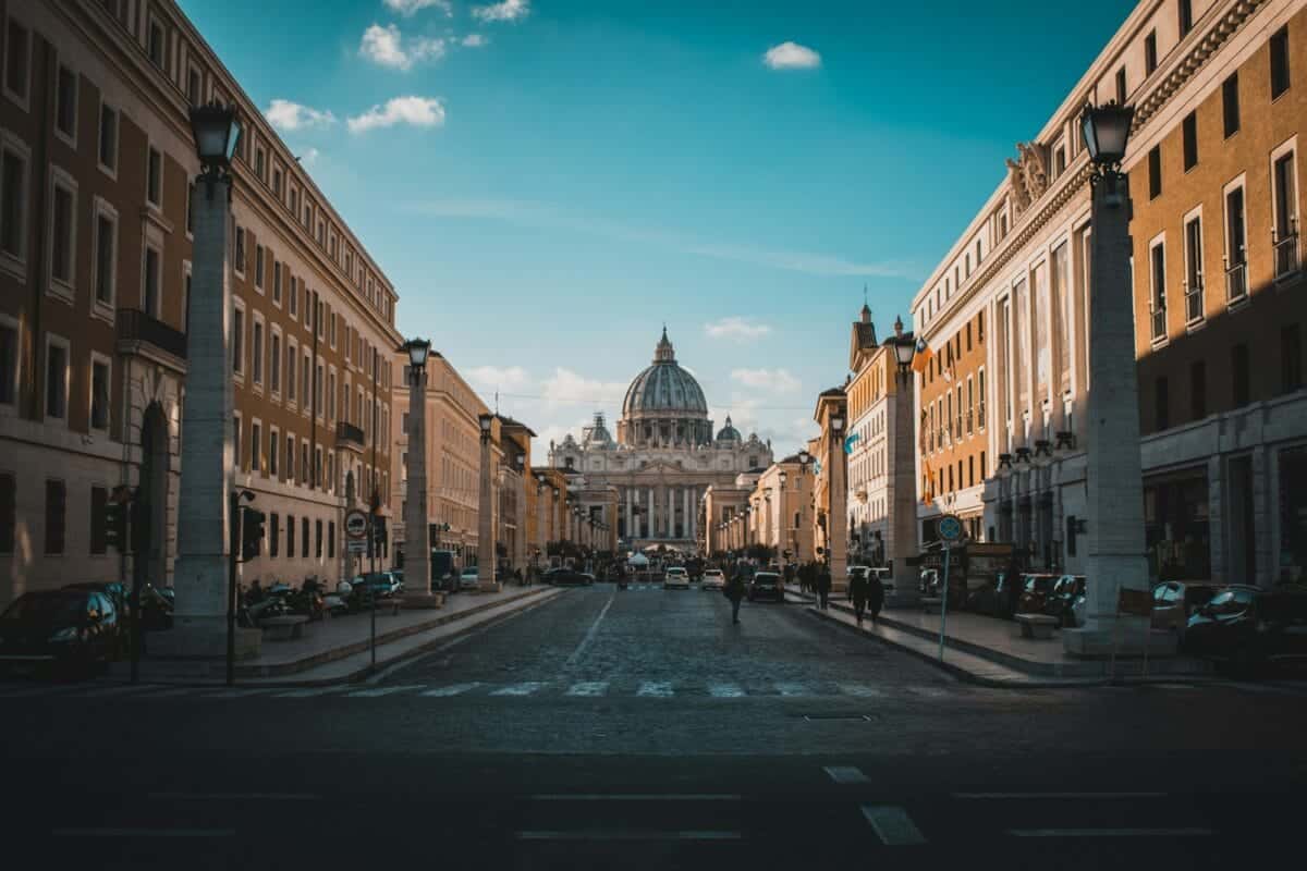 Vatican City Tours a city street with a domed building in the background