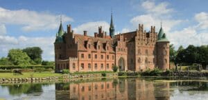 Denmark Tours brown concrete building near body of water during daytime