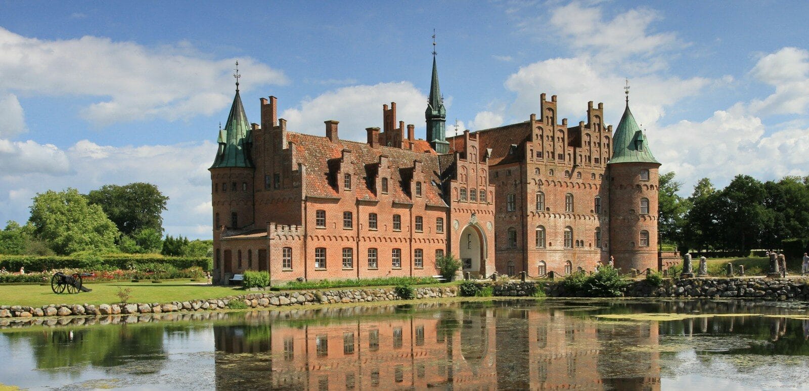 Denmark Tours brown concrete building near body of water during daytime