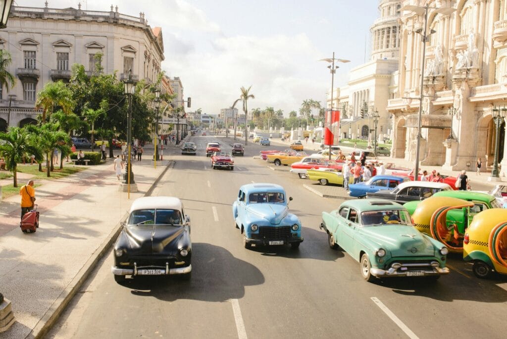Cuba Travel Guide Must-See Places in Cuba three assorted-colored vintage car on road