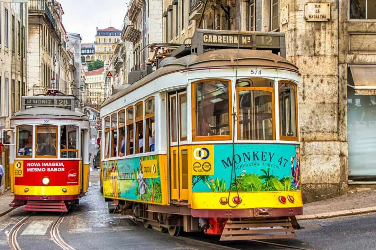 lisbon tours yellow and white tram on street during daytime