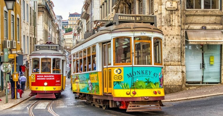 lisbon tours yellow and white tram on street during daytime