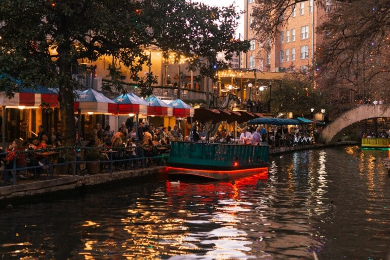 San Antonio Tours people sitting near body of water