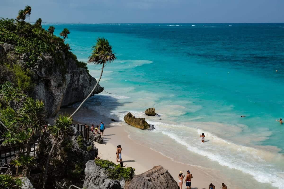 Riviera Maya Travel Guide people walking on seashore during daytime