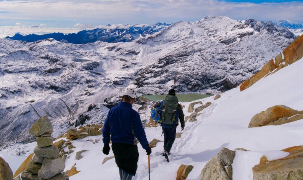 Adventure Travel a couple of people walking up a snow covered slope