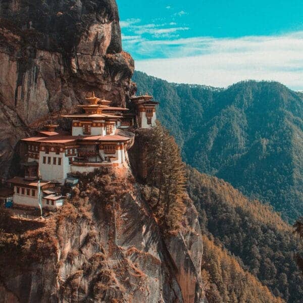 Bhutan Travel Guide Paro Taktsang temple in Bhutan viewing mountain under blue and white sky
