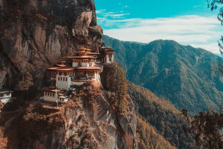 Bhutan Travel Guide Paro Taktsang temple in Bhutan viewing mountain under blue and white sky