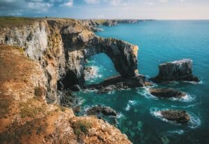 Wales Tours gray and brown rock formation and mountain near body of water