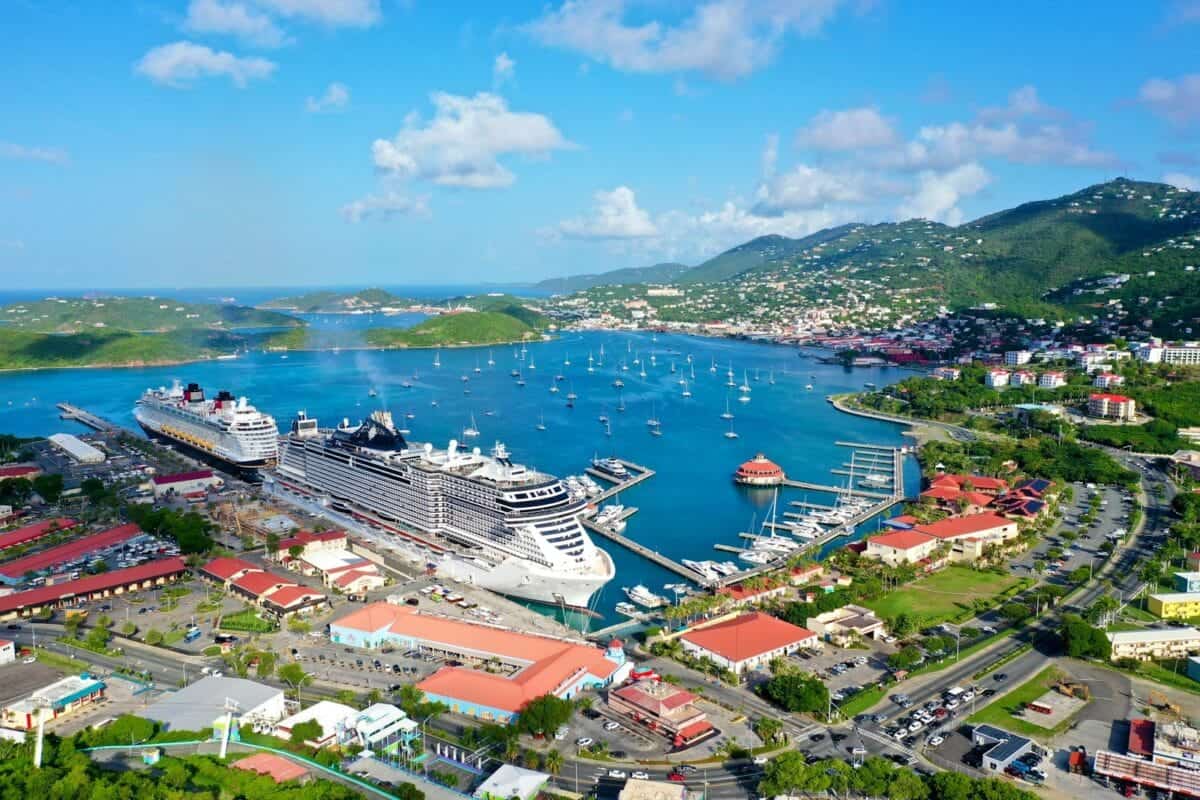 US Virgin Islands Travel Guide a cruise ship docked in a harbor next to a city