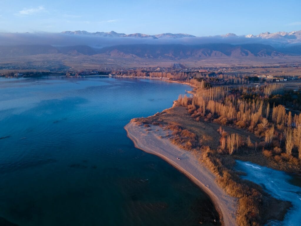 Kyrgyzstan Travel Guide aerial view of body of water near trees during daytime
