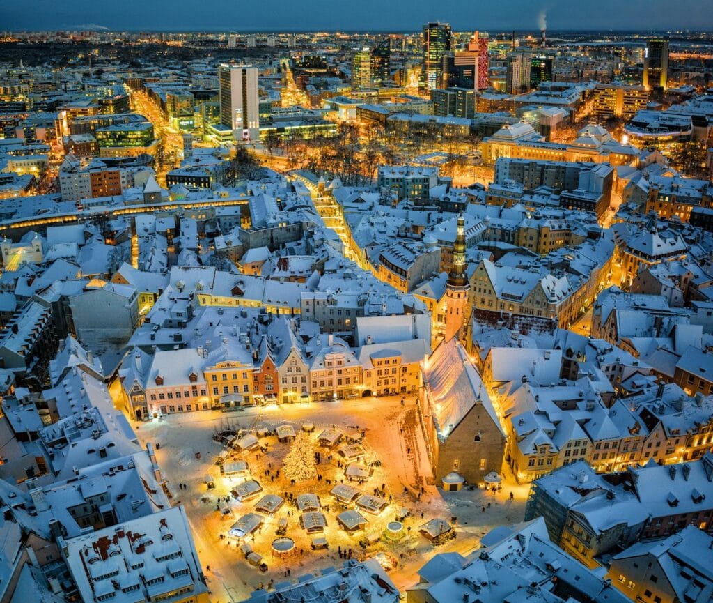 Estonia Travel Guide an aerial view of a snowy city at night
