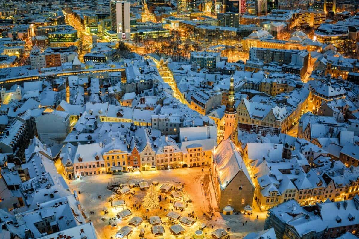 Estonia Travel Guide an aerial view of a snowy city at night