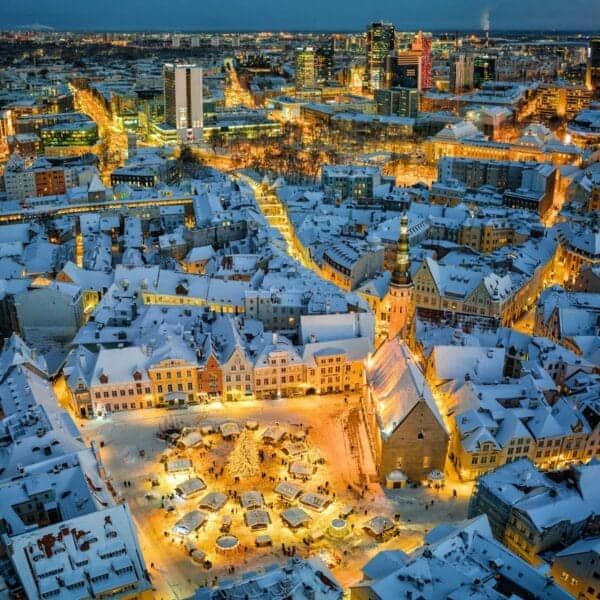 Estonia Travel Guide an aerial view of a snowy city at night