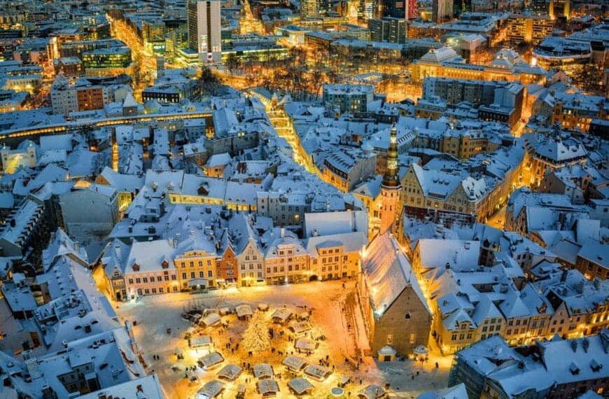 Estonia Travel Guide an aerial view of a snowy city at night
