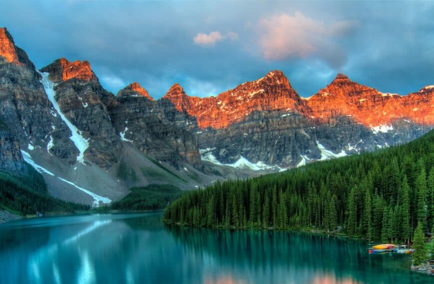 alberta travel guide calm body of water and mountains wallpaper