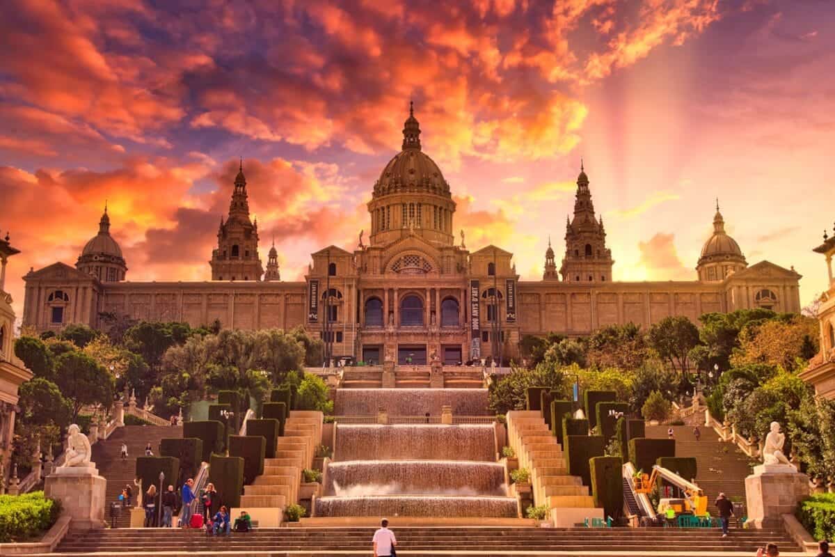 barcelona tours people sitting on bench near building during sunset
