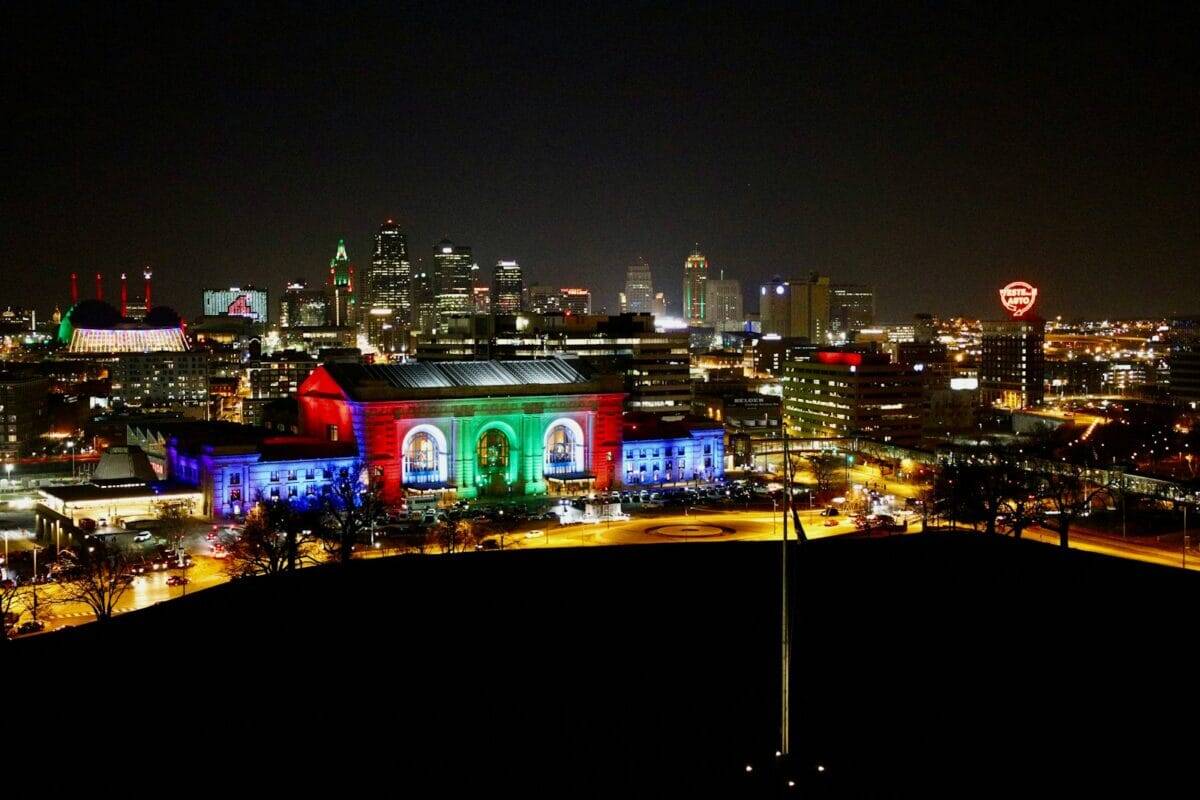 Kansas Travel Guide a view of a city at night from a hill
