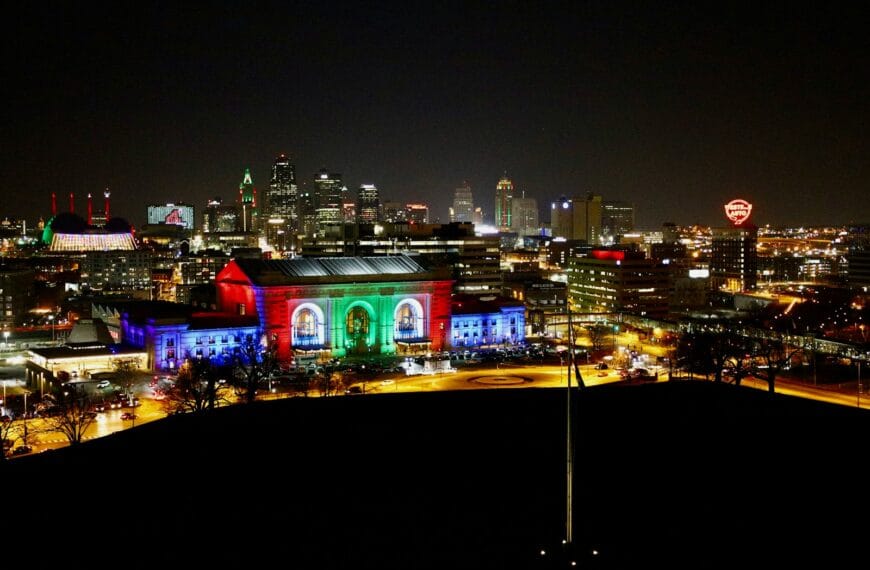 Kansas Travel Guide a view of a city at night from a hill