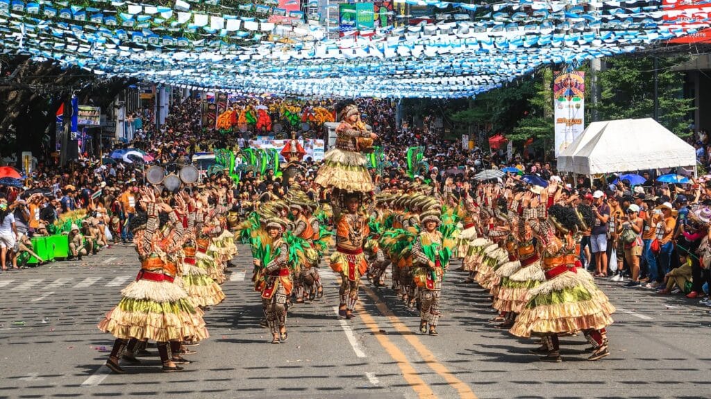 Philippines Culture people in green and brown traditional dress walking on street during daytime