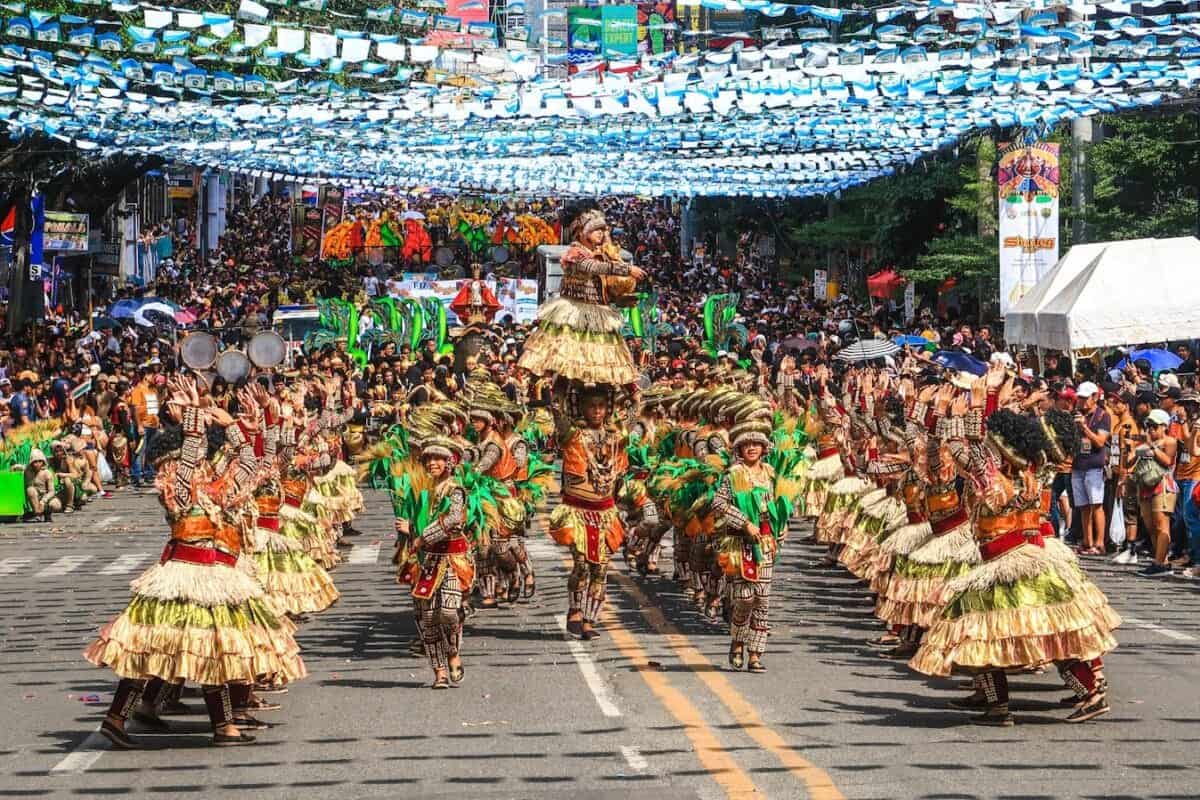 Philippines Culture people in green and brown traditional dress walking on street during daytime