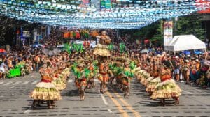 Philippines Culture people in green and brown traditional dress walking on street during daytime