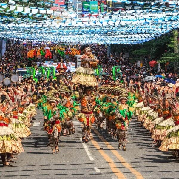 Philippines Culture people in green and brown traditional dress walking on street during daytime