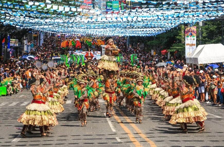 Philippines Culture people in green and brown traditional dress walking on street during daytime