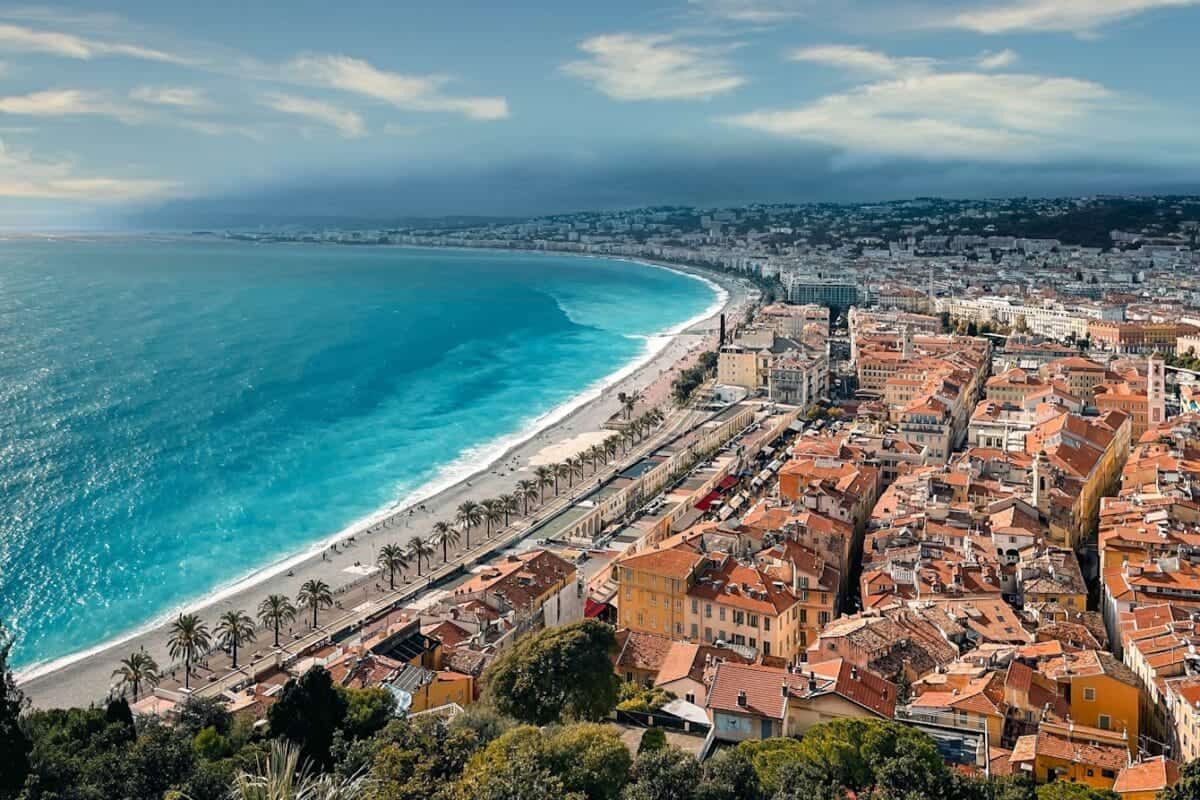 Nice Travel Guide an aerial view of a city next to the ocean