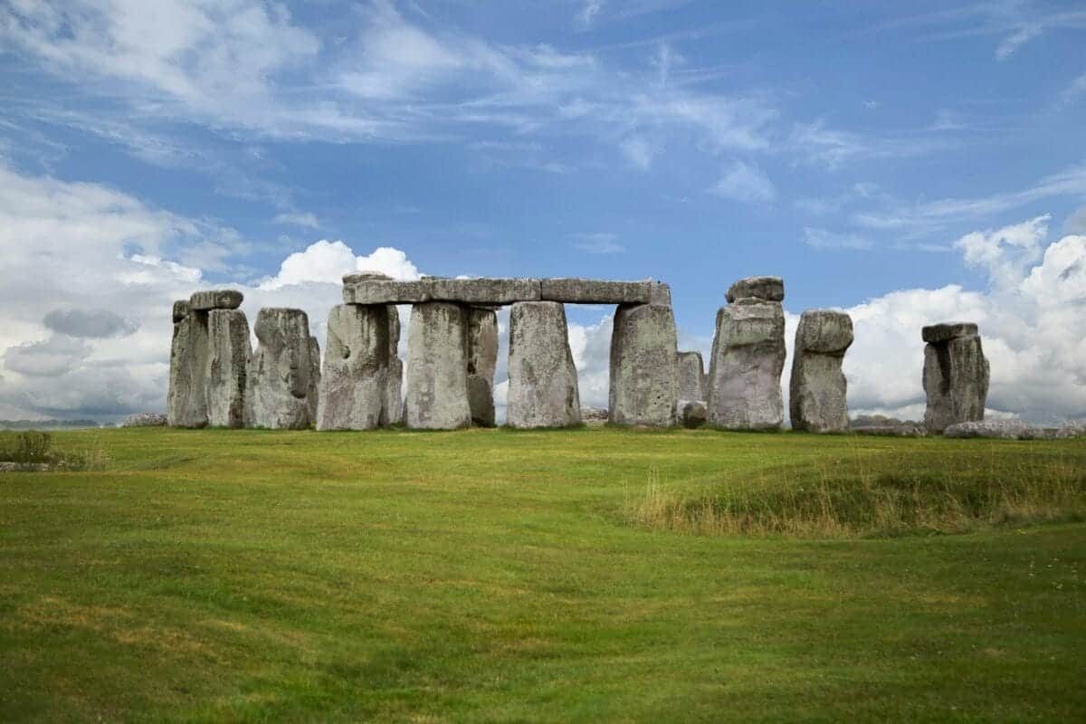 Stonehenge gray rock formation on green grass field under blue sky during daytime