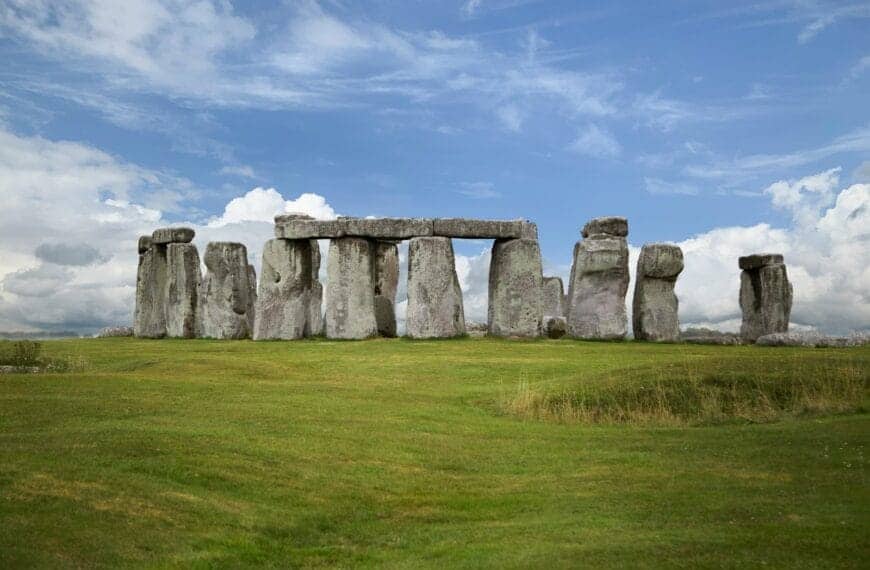 Stonehenge gray rock formation on green grass field under blue sky during daytime