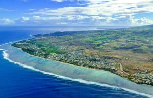 Réunion Island Travel Guide aerial view of green and brown field beside body of water during daytime