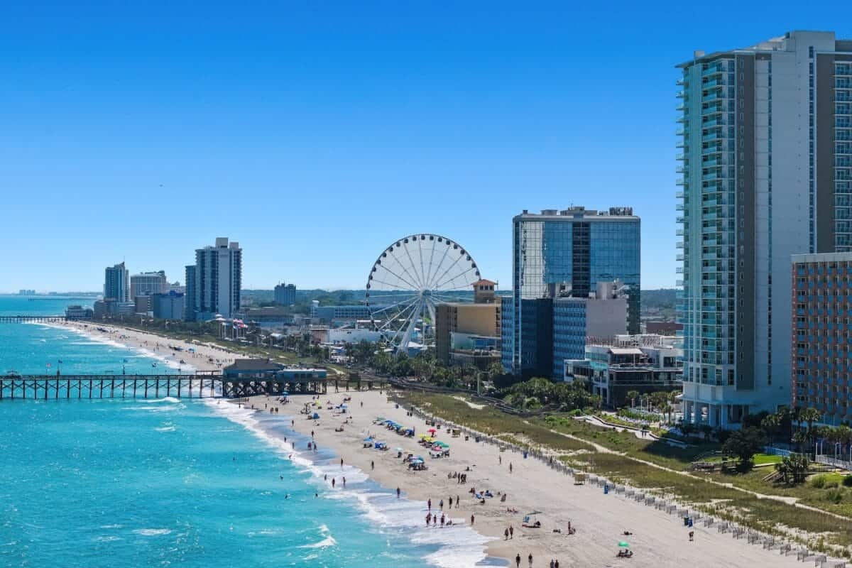 myrtle beach travel guide A view of a beach with a ferris wheel in the distance
